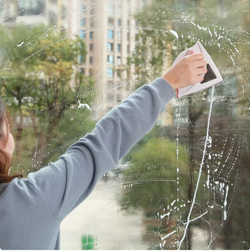 Person cleaning a window with a squeegee